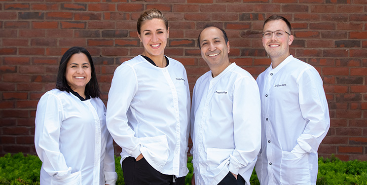 four dentists smiling